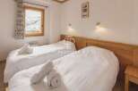 Cozy bedroom with two beds, perfect for a comfortable stay.