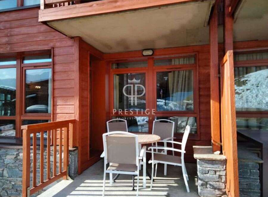 Discover a charming property with a cozy outdoor seating area, perfect for enjoying the mountain views.