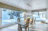 Experience the serene beauty of winter from this stunning dining room.