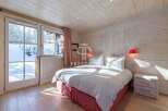 Experience the charm of this cozy bedroom, featuring a stunning wooden interior that exudes warmth and comfort.