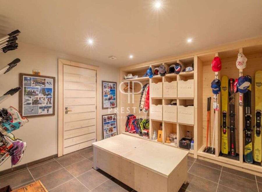 Discover the ultimate ski storage solution in this stunning property! Featuring custom-built wooden shelving and storage, this space is designed to keep your gear organized and accessible.