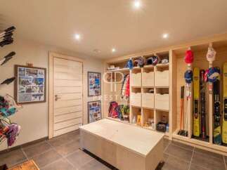 Discover the ultimate ski storage solution in this stunning property! Featuring custom-built wooden shelving and storage, this space is designed to keep your gear organized and accessible.