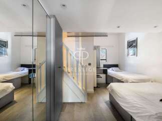 Discover a modern and stylish property featuring multiple single beds, perfect for shared living or a guest room setup.
