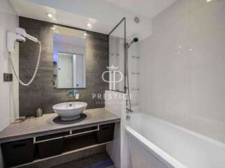 Modern bathroom design featuring a sleek vanity with a vessel sink and ample storage.