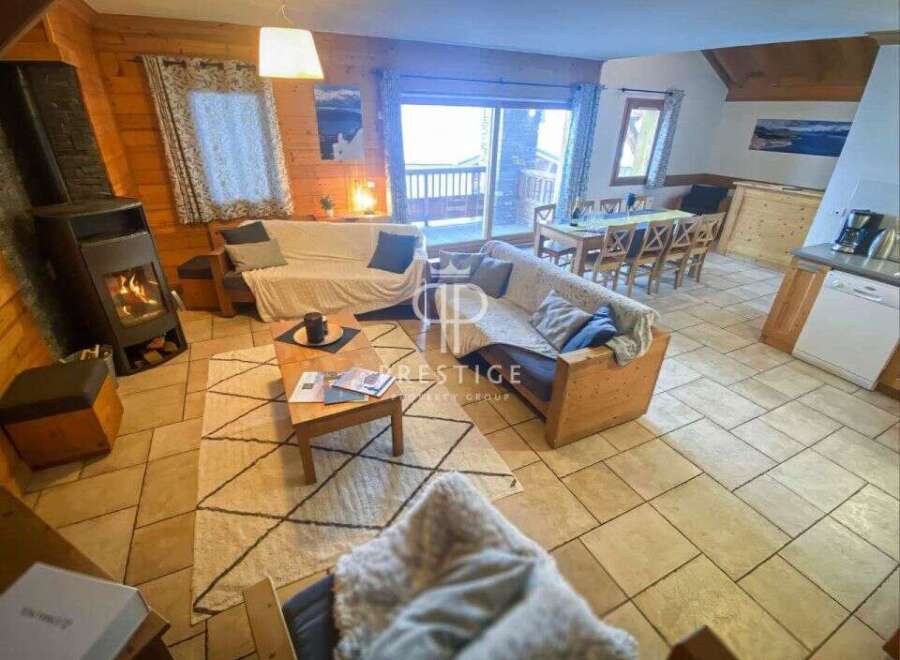 Cozy up in this charming cabin! Featuring a warm fireplace, comfortable seating, and a dining area, it's perfect for relaxing.