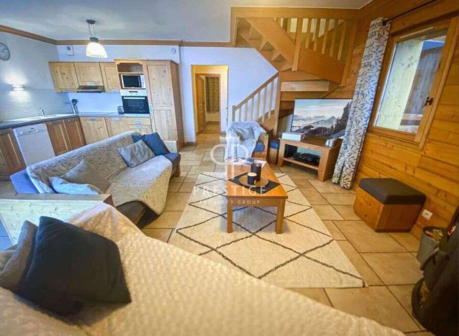 Cozy chalet living at its finest! This charming property boasts a warm and inviting interior with wooden accents throughout.