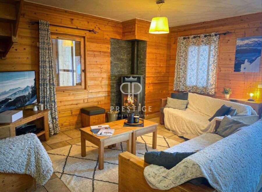 Cozy up in this charming cabin! Featuring a warm wooden interior, a fireplace, and comfortable seating, this space is perfect for relaxation.