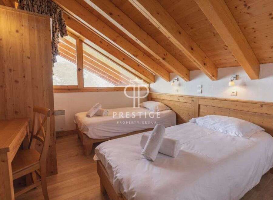 Discover the charm of this cozy bedroom, featuring two comfortable beds perfect for a relaxing stay.
