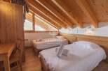 Discover the charm of this cozy bedroom, featuring two comfortable beds perfect for a relaxing stay.