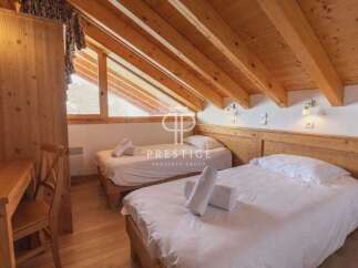 Discover the charm of this cozy bedroom, featuring two comfortable beds perfect for a relaxing stay.