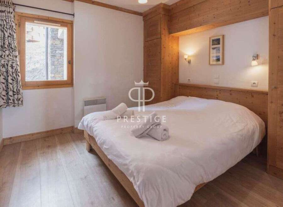 Discover a cozy bedroom with a wooden bed frame and matching wooden accents.