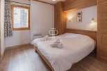 Discover a cozy bedroom with a wooden bed frame and matching wooden accents.