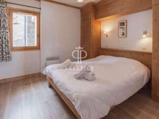 Discover a cozy bedroom with a wooden bed frame and matching wooden accents.