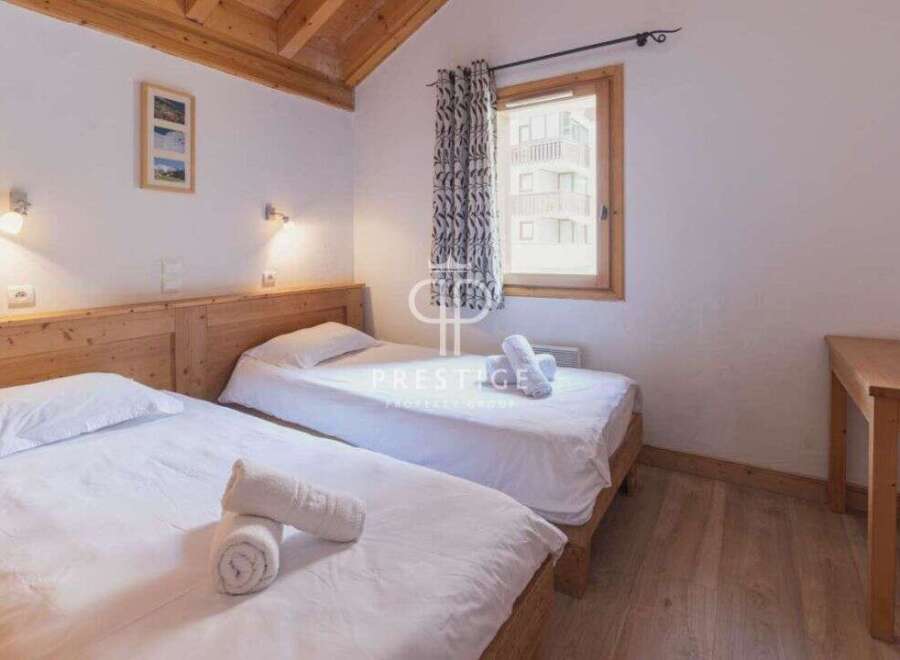 Discover a cozy bedroom with two comfortable single beds, perfect for a relaxing stay.