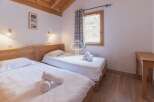 Discover a cozy bedroom with two comfortable single beds, perfect for a relaxing stay.