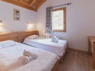 Discover a cozy bedroom with two comfortable single beds, perfect for a relaxing stay.