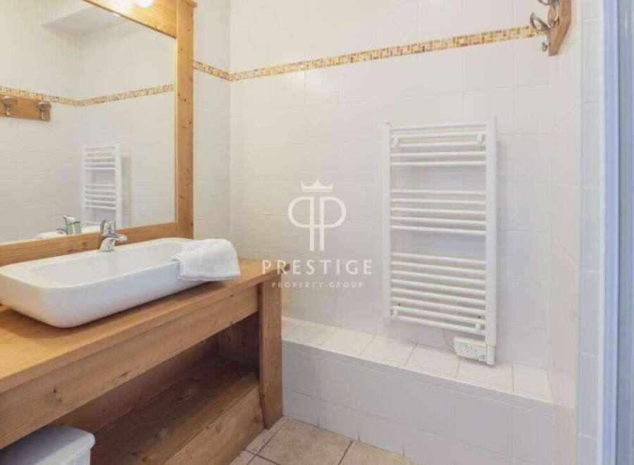 Discover a stylish bathroom featuring a modern sink and a sleek towel rack.