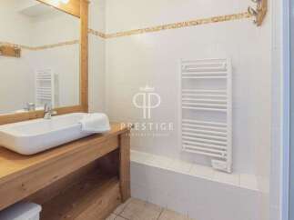 Discover a stylish bathroom featuring a modern sink and a sleek towel rack.