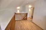 Discover this stunning property featuring a beautifully designed wooden staircase and flooring, creating a warm and inviting atmosphere.