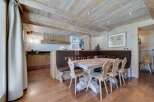 Experience rustic charm in this stunning property, featuring a beautifully designed dining area with wooden accents.