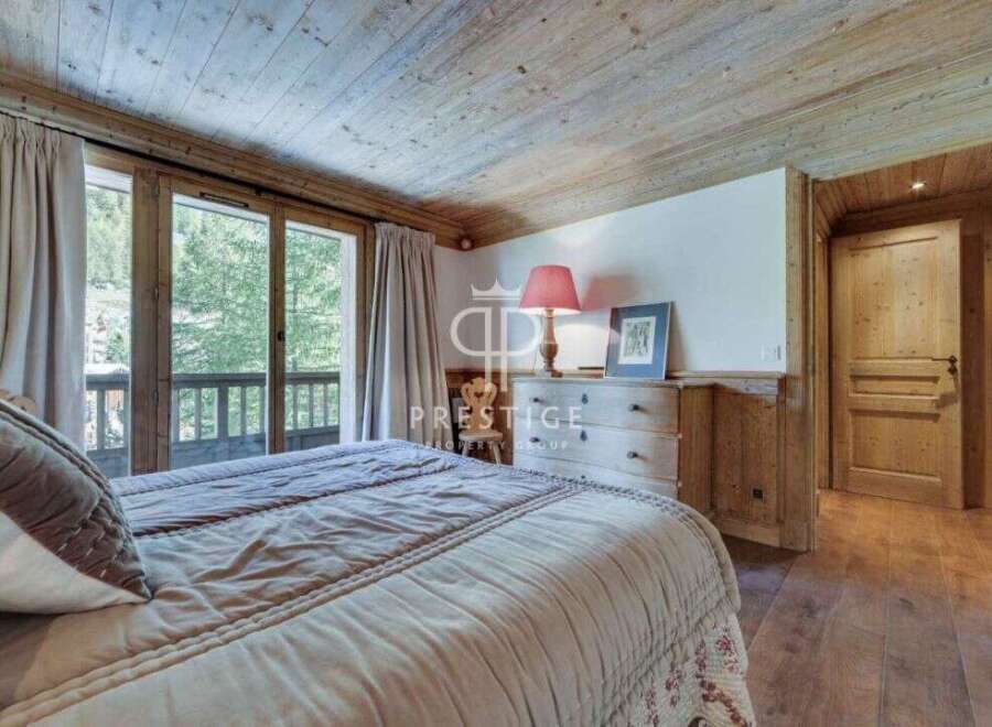 Discover the charm of this exquisite bedroom, featuring a cozy bed and elegant curtains.