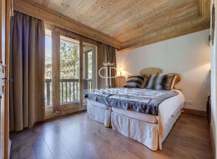 Discover the charm of this cozy bedroom, featuring a warm wooden ceiling and flooring.