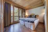 Discover the charm of this cozy bedroom, featuring a warm wooden ceiling and flooring.