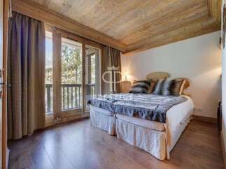 Discover the charm of this cozy bedroom, featuring a warm wooden ceiling and flooring.