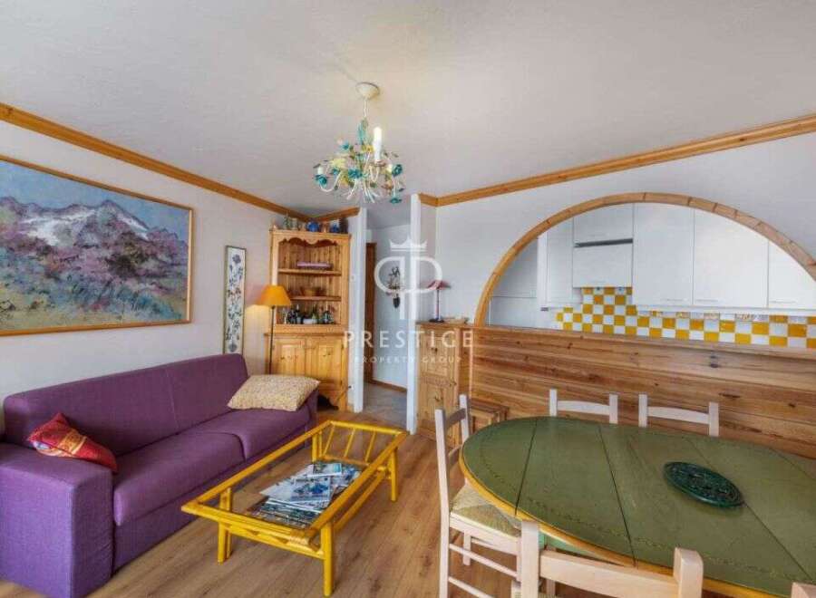 Discover this charming property featuring a cozy living area with a vibrant purple sofa and a stylish coffee table.