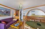 Discover this charming property featuring a cozy living area with a vibrant purple sofa and a stylish coffee table.
