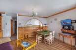 Discover a cozy living space with a charming dining area.