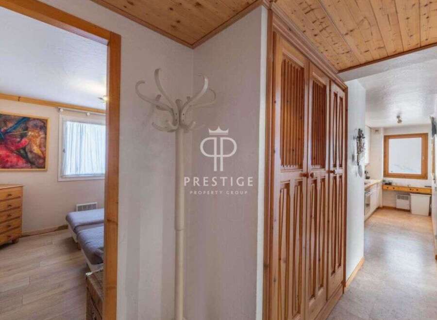 Discover the charm of this property, featuring elegant wooden cabinetry and a welcoming hallway.