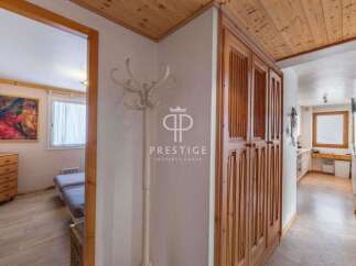 Discover the charm of this property, featuring elegant wooden cabinetry and a welcoming hallway.