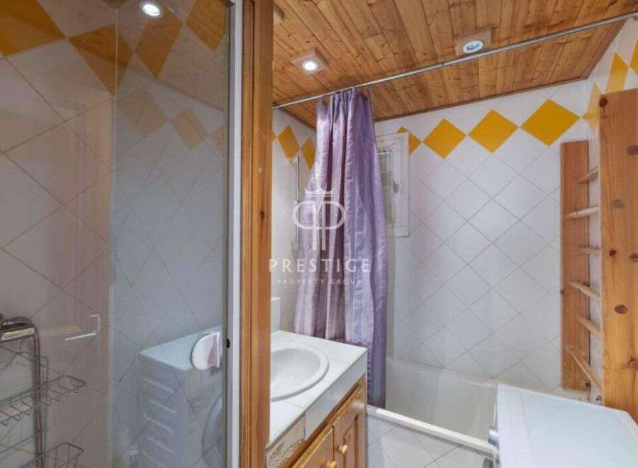 This charming bathroom features a unique design with wooden accents and a cozy atmosphere.