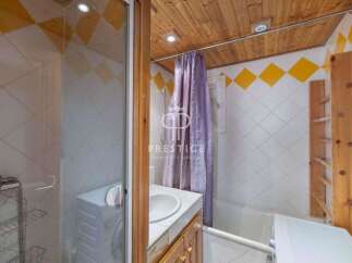 This charming bathroom features a unique design with wooden accents and a cozy atmosphere.