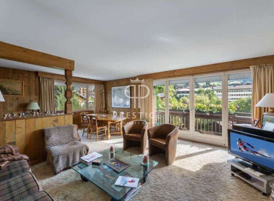 Experience the charm of this cozy living room, featuring warm wooden accents and a welcoming atmosphere.