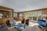 Experience the charm of this cozy living room, featuring warm wooden accents and a welcoming atmosphere.