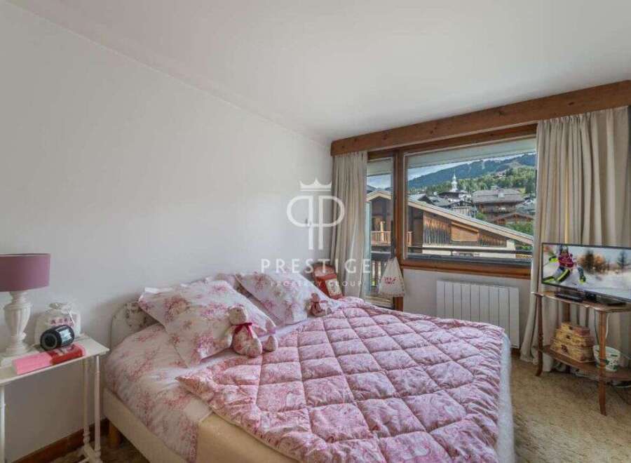 Cozy bedroom with a stunning mountain view.