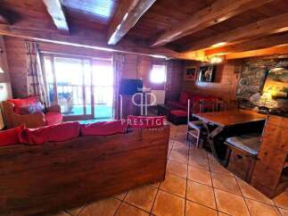 Discover the charm of this cozy property, featuring a rustic interior with wooden beams and paneling.