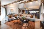 Experience luxury living in this stunning property, featuring a spacious living area with a modern kitchen.