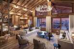 Luxury chalet with breathtaking mountain views, featuring a spacious open-plan living area with a cozy fireplace and plush furnishings.