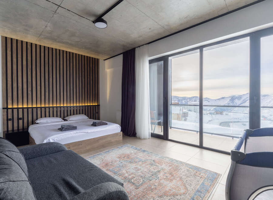 Experience luxury in this stunning bedroom with breathtaking mountain views.