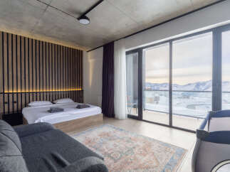 Experience luxury in this stunning bedroom with breathtaking mountain views.