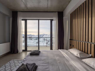 Experience breathtaking mountain views from this luxurious bedroom.
