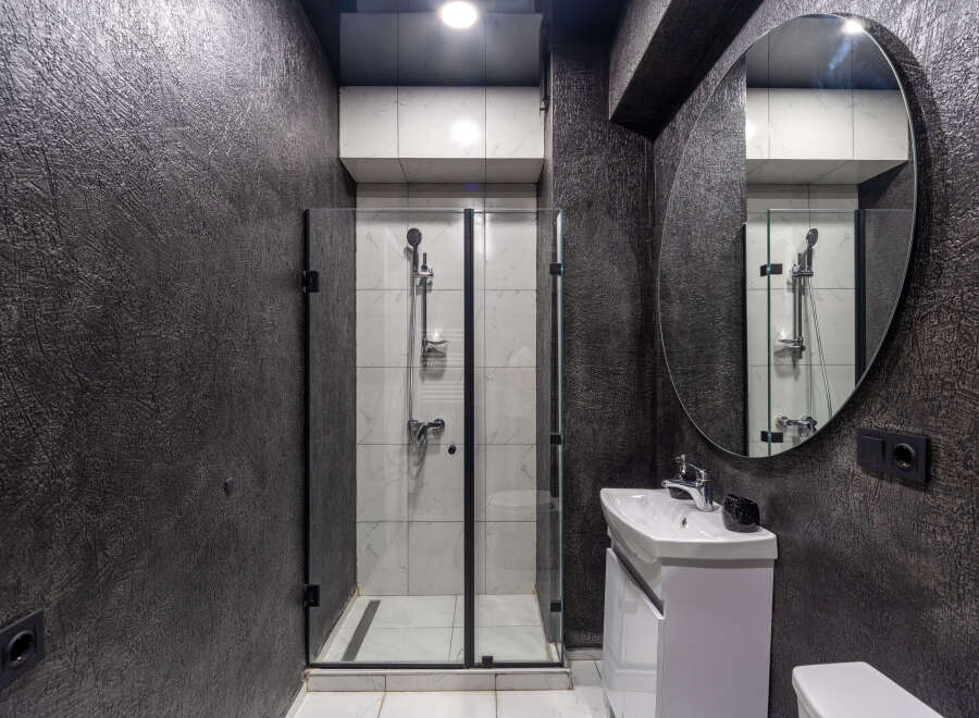 Modern bathroom design featuring a sleek shower enclosure and a stylish vanity.