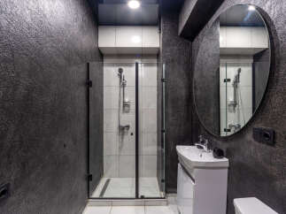 Modern bathroom design featuring a sleek shower enclosure and a stylish vanity.
