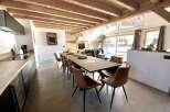 This stunning chalet boasts a spacious open-plan living area with floor-to-ceiling windows offering breathtaking views.