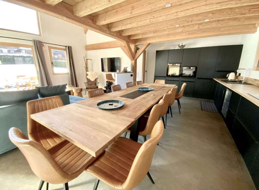 This stunning chalet boasts a spacious open-plan living area with floor-to-ceiling windows offering breathtaking views.