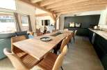 This stunning chalet boasts a spacious open-plan living area with floor-to-ceiling windows offering breathtaking views.