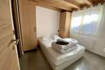Cozy chalet bedroom with wooden accents and built-in wardrobes.